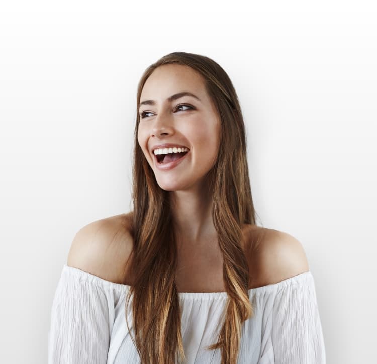 Woman in white top smiling and laughing