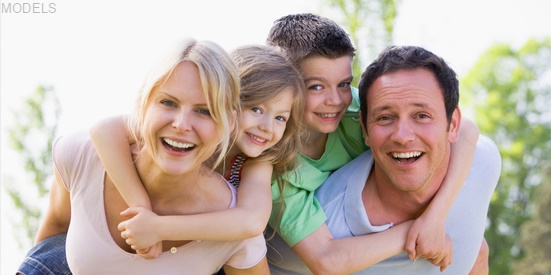 Smiling mom and dad with kids on their backs