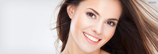 Closeup of smiling young woman with dark hair