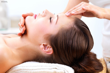 Woman with head on a folded towel getting facial