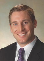 Headshot of Dr. Harkins in a dark suit and necktie