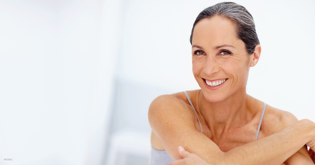 Older woman smiling with arms crossed