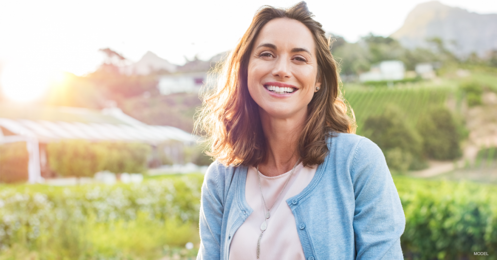 Smiling woman in a green field