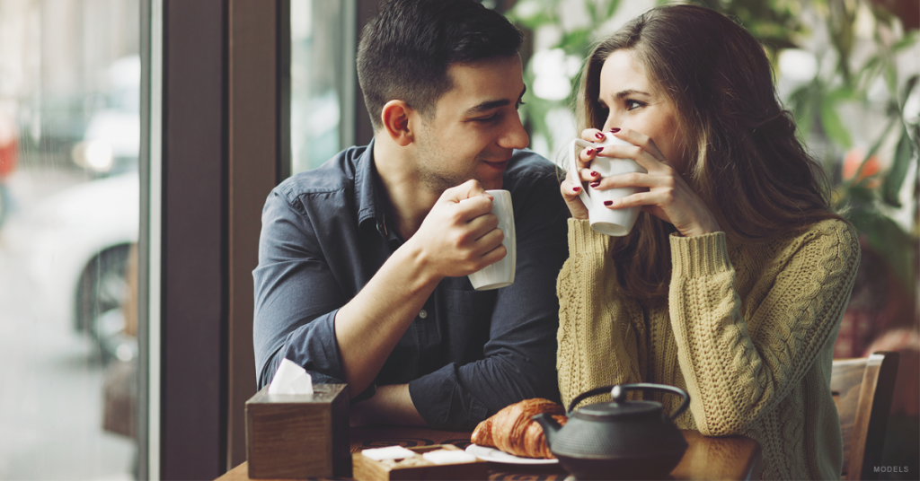 Couple sharing a supportive glance at a coffee shop (models)