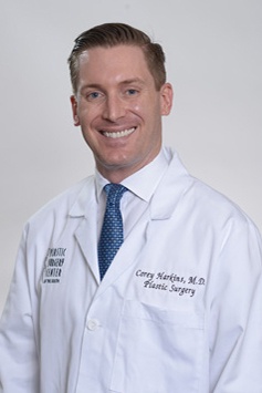 Dr. Corey Harkins in a white labcoat