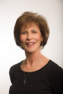 Headshot of Judy wearing a black top