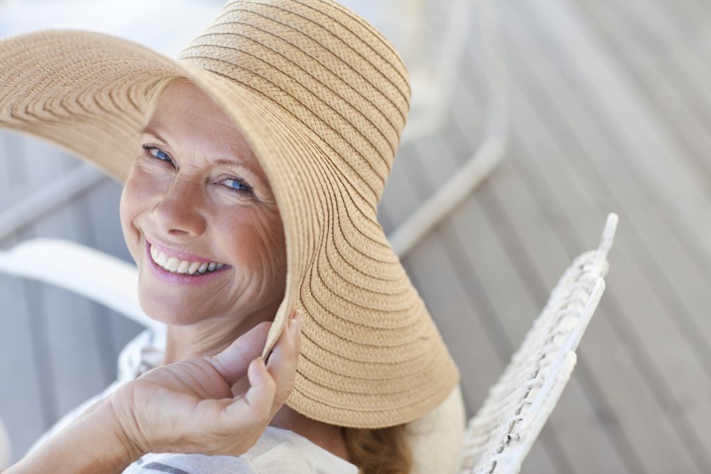Woman smiling while wearing large sunhat