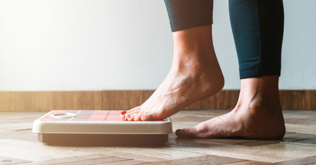 Woman stepping onto a scale