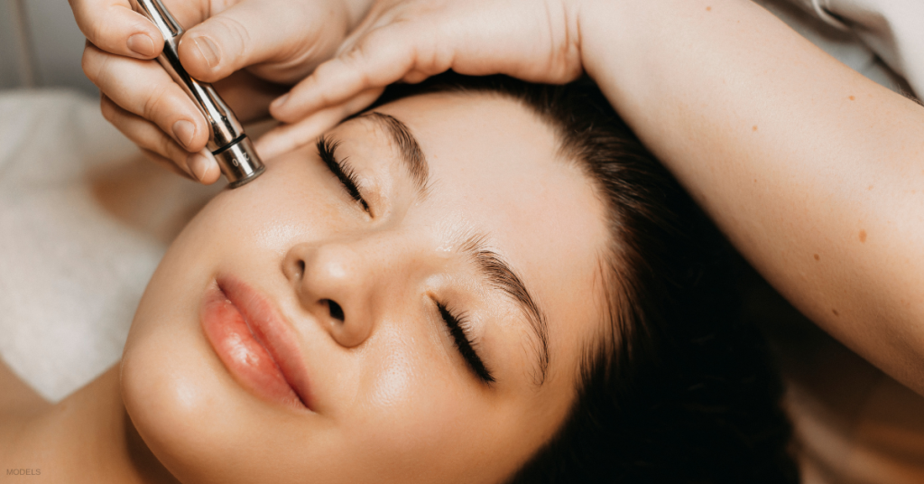 Woman receiving microneedling treatment (model)