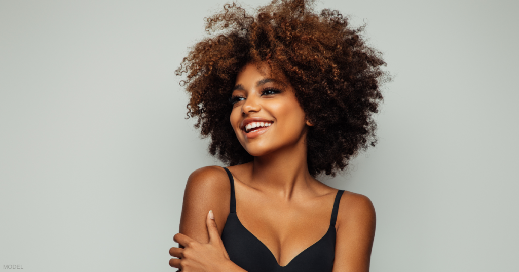 Beautiful woman in black bra smiling (model)