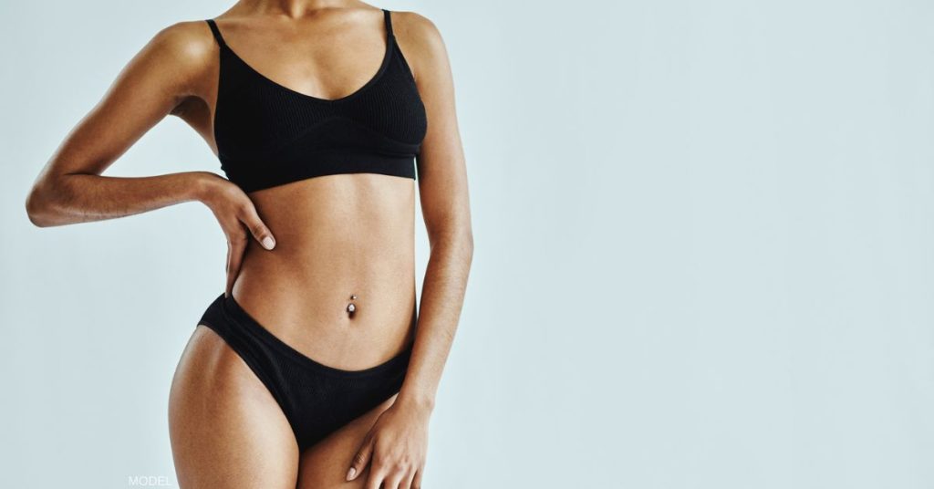 woman's body wearing a black bralette and black underwear (model)